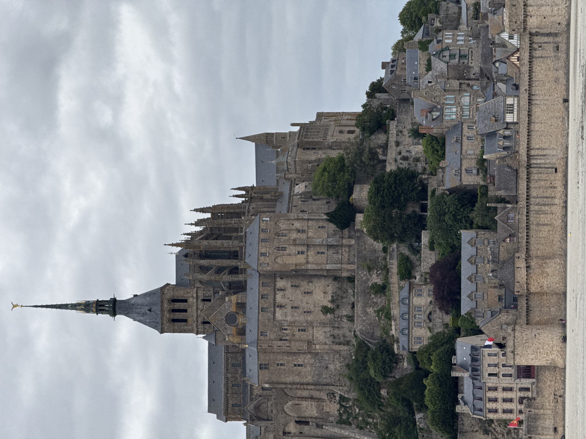 Mont-Saint-Michel abbey photographed under cloudy skies in France