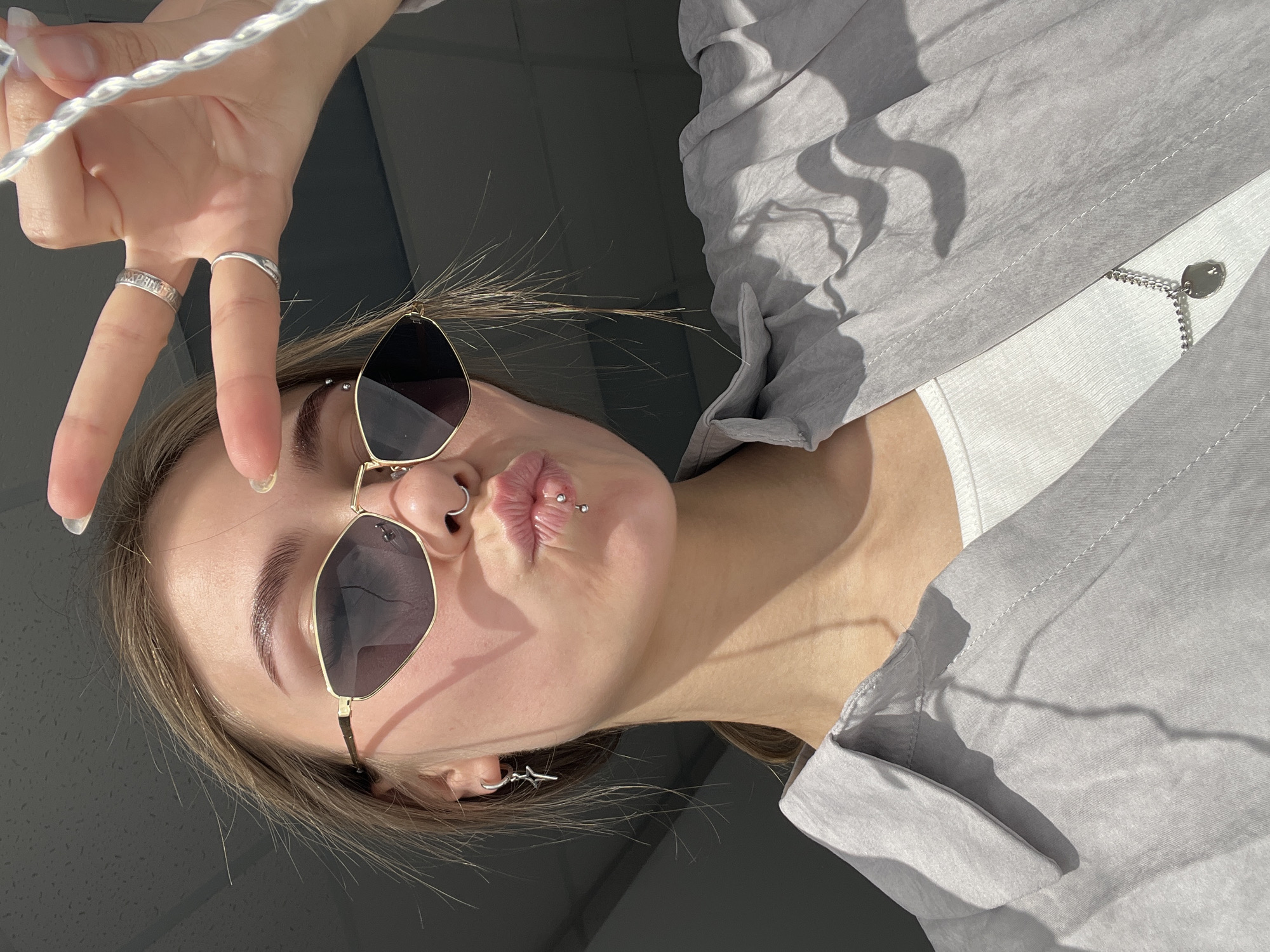 Young women photograph themselves during morning selfie session