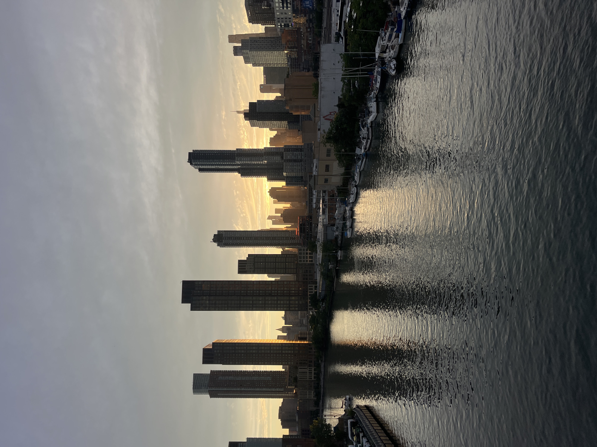 Golden hour on a NYC bridge, skyline views through chain-link
