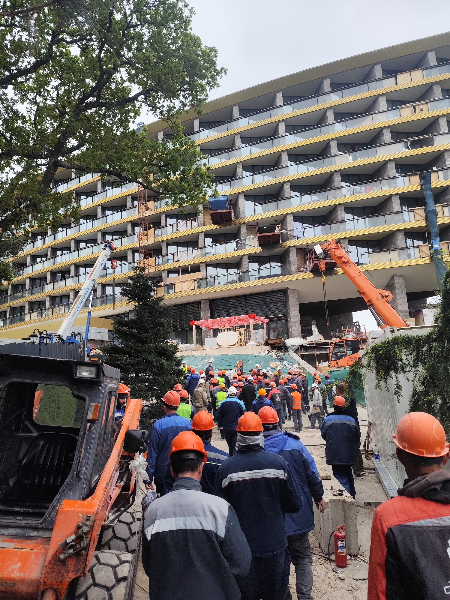 Construction crew active at Simeiz building site with heavy equipment