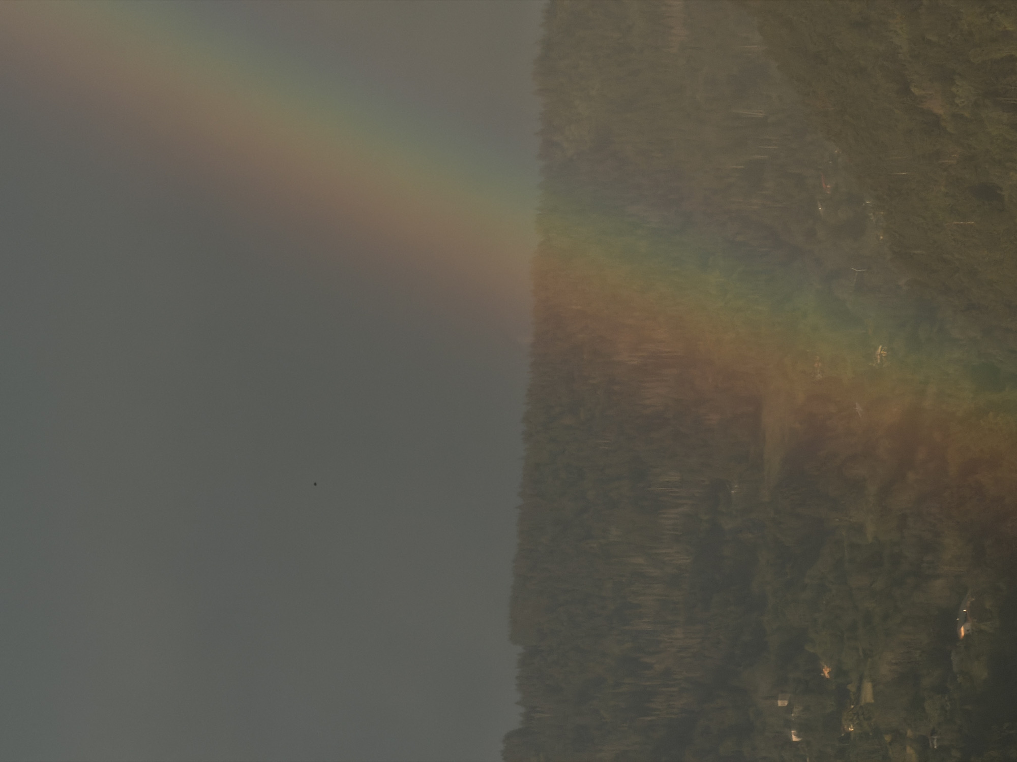 Rainbow over Cluses mountains on a stormy June evening