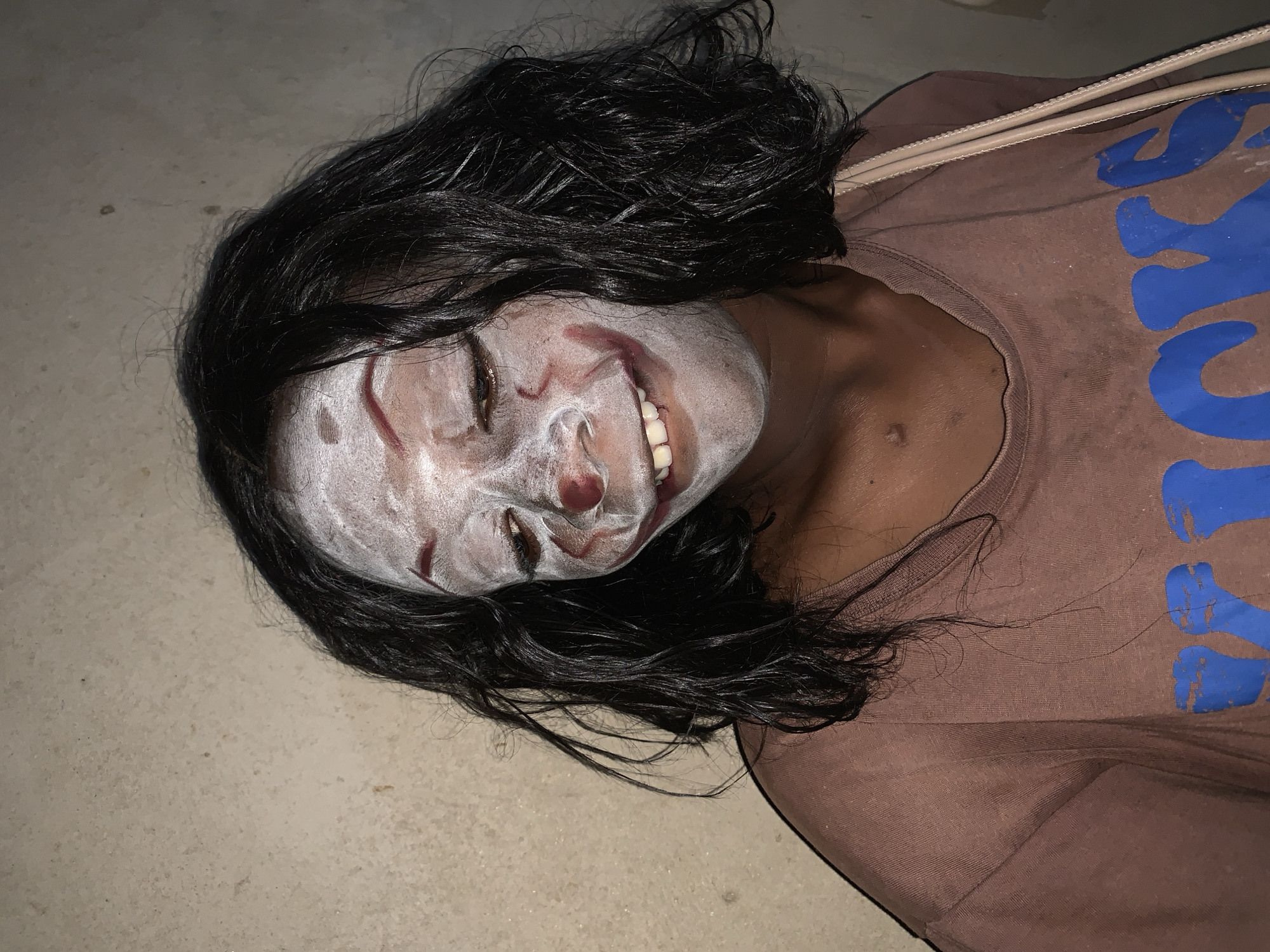 Person in theatrical makeup spotted on concrete in Agban