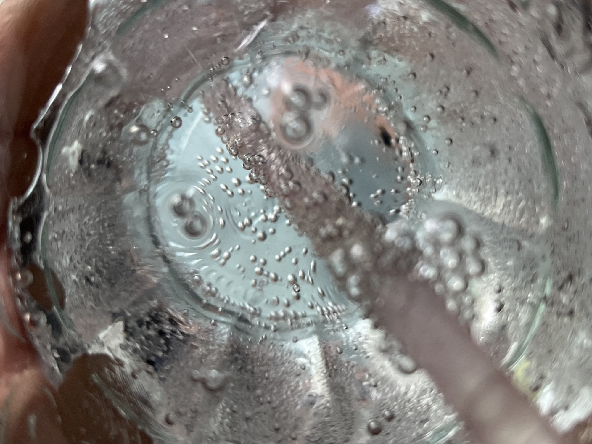 Person drinks sparkling water in Dhaka