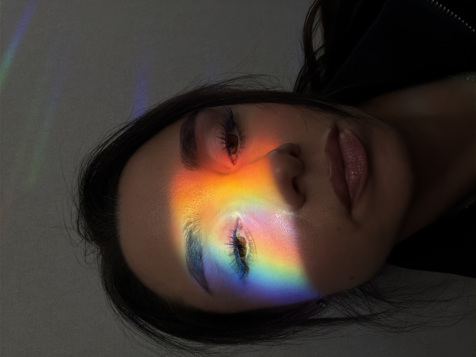 Person experiments with prism light effects in Saint Petersburg apartment