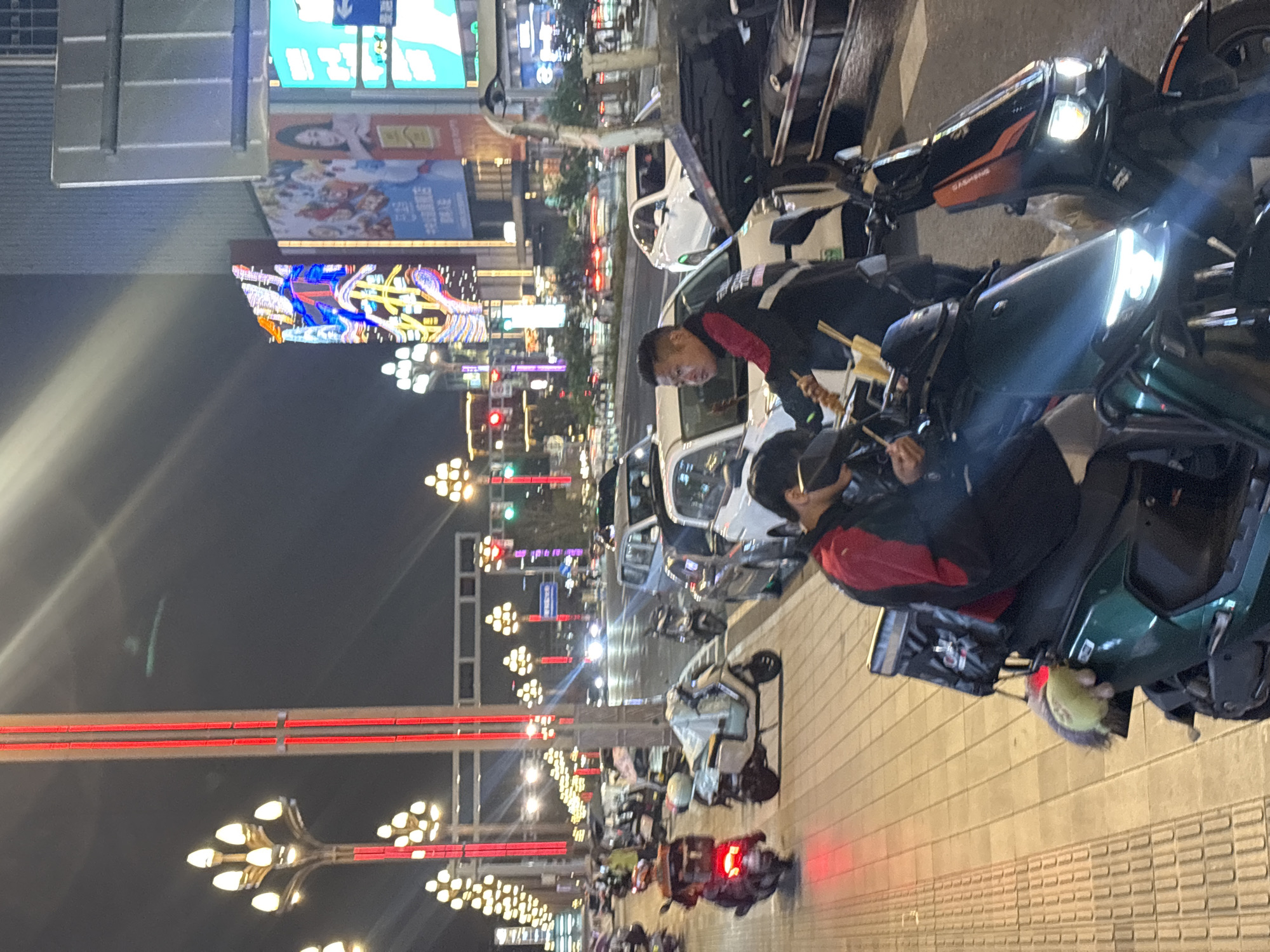 Street food scene captured in nighttime Liangjiang, China