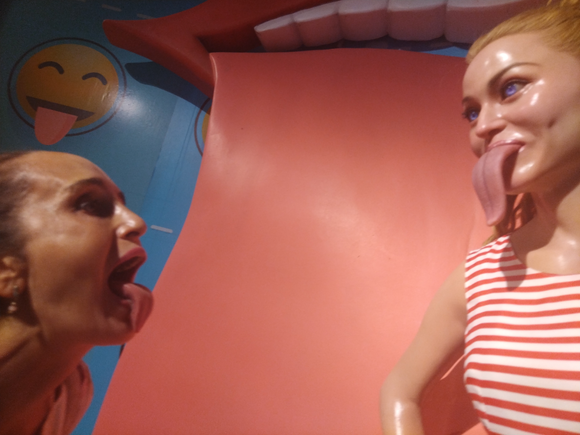 Woman tours wax museum, poses with celebrity figures