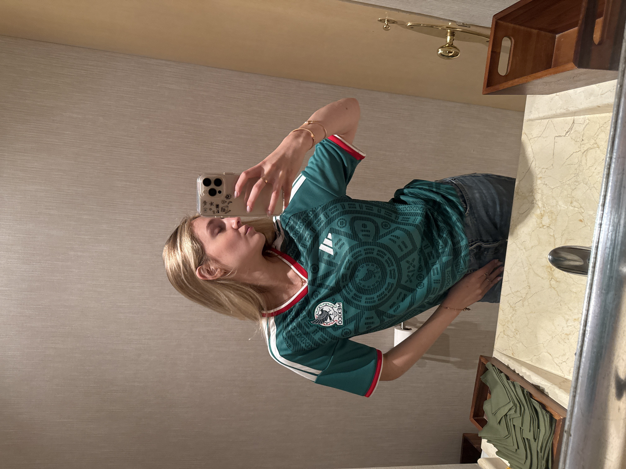 Woman in Mexico jersey takes selfies with dog companion