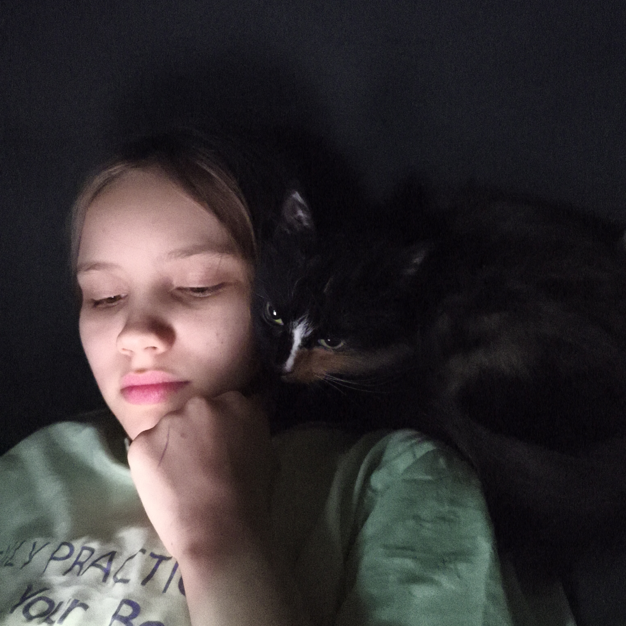 Woman photographed with cat in indoor low-light setting