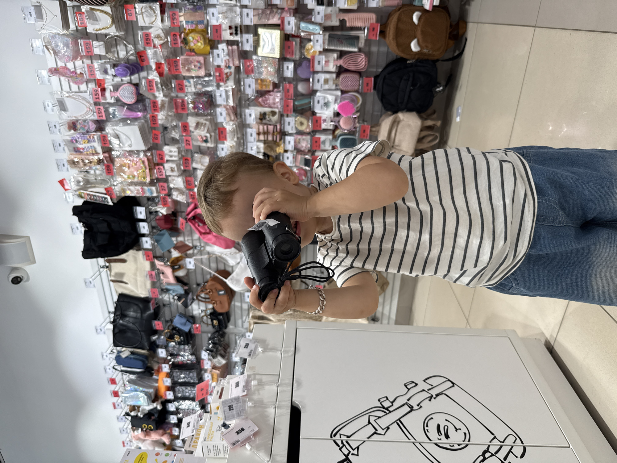 Kids trying out toys and gadgets in a Zhukovo store