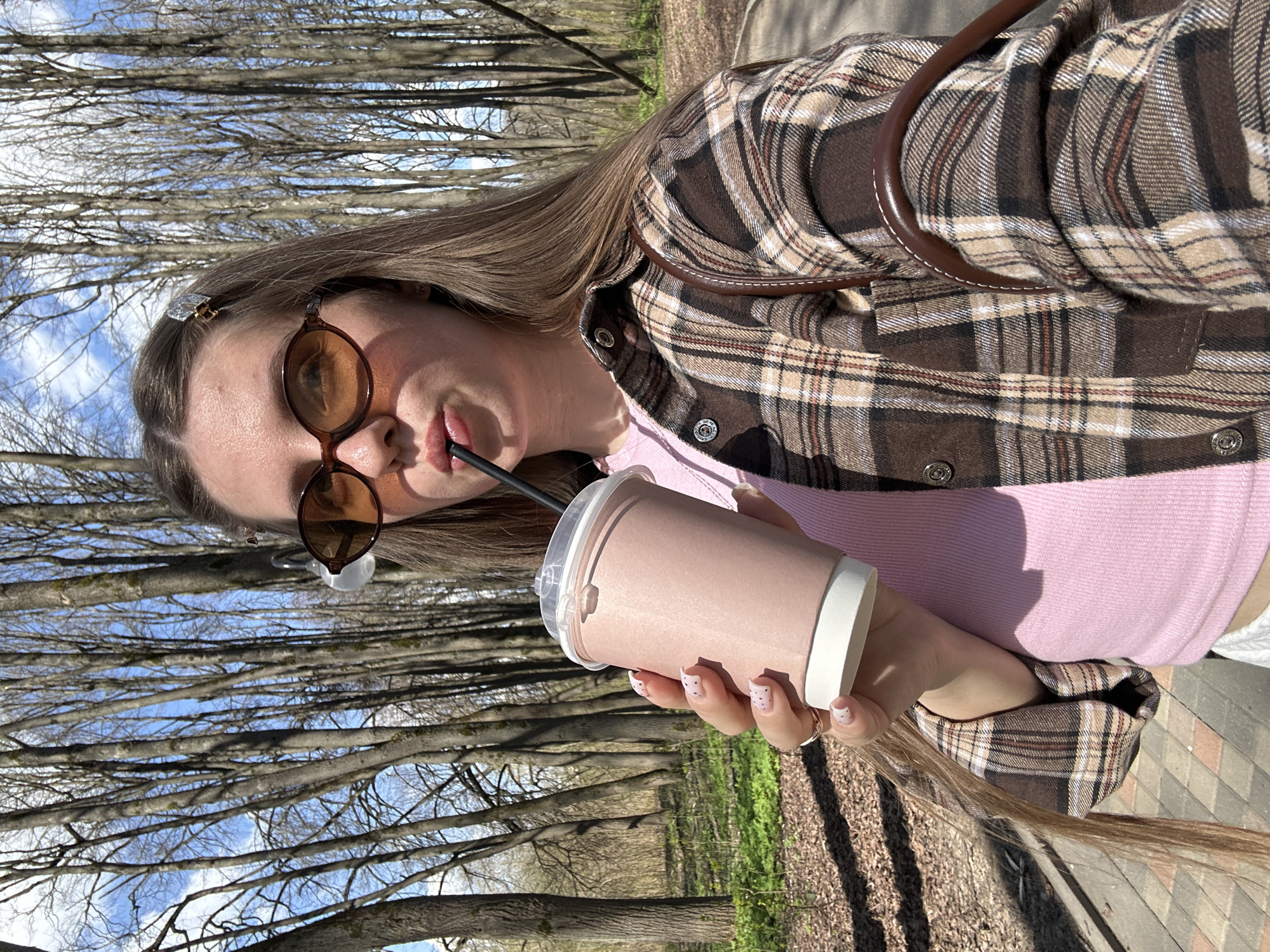 Woman with drink spotted outdoors in sunny Klin, Russia