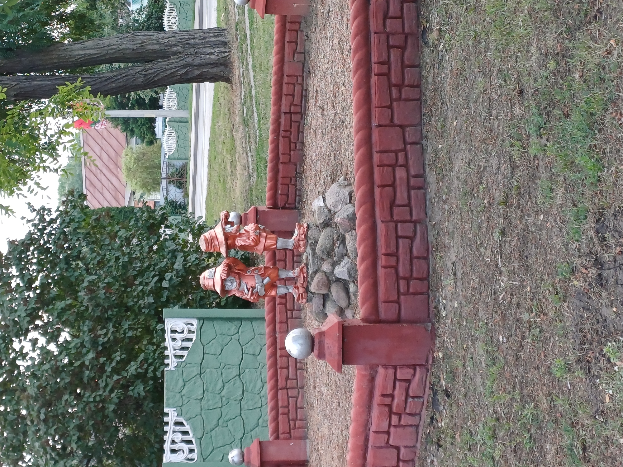 Gnome statues and moose topiary in a Kobryn garden