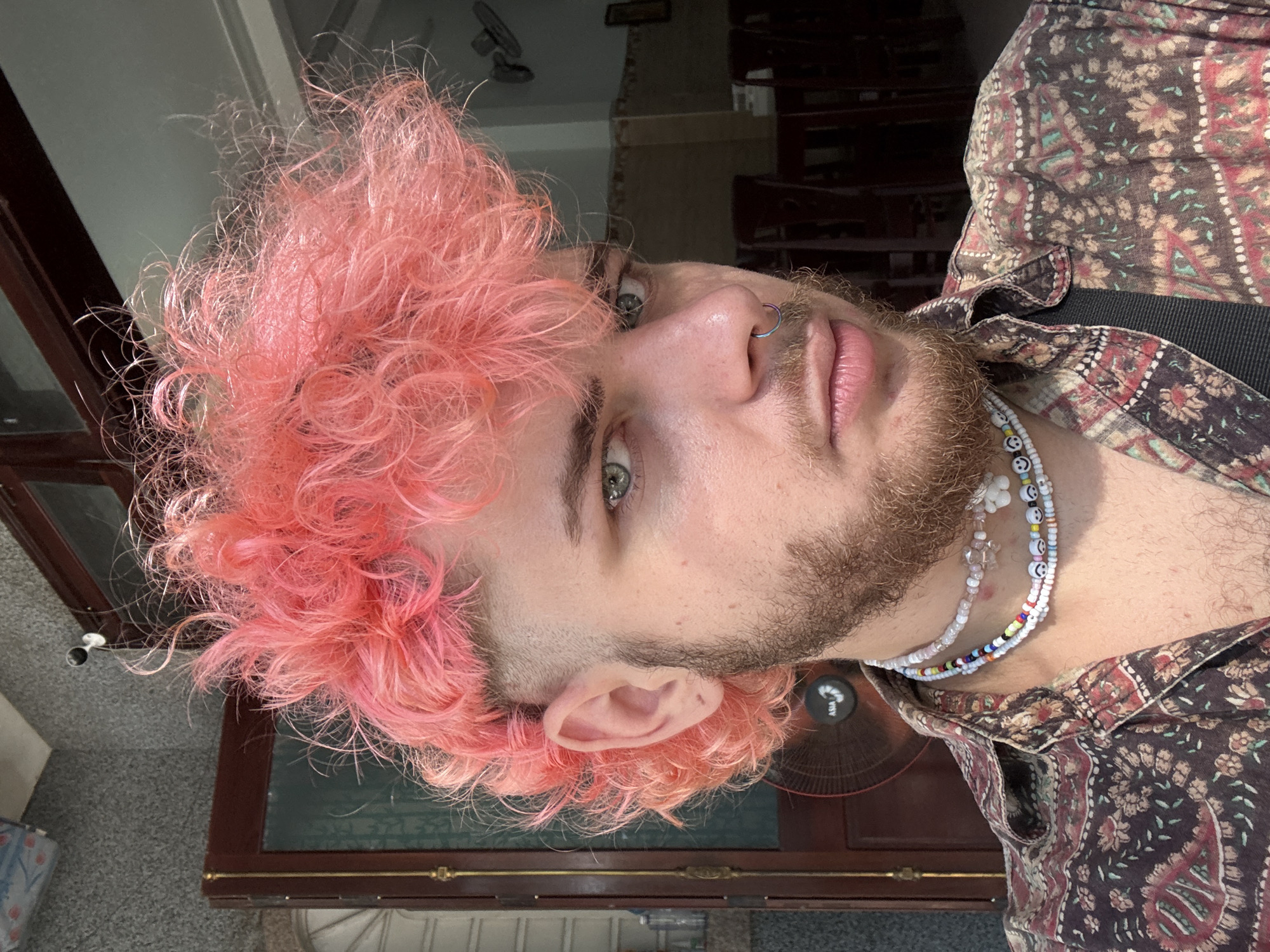 Pink-haired individual photographed on Đà Nẵng street near motorbikes