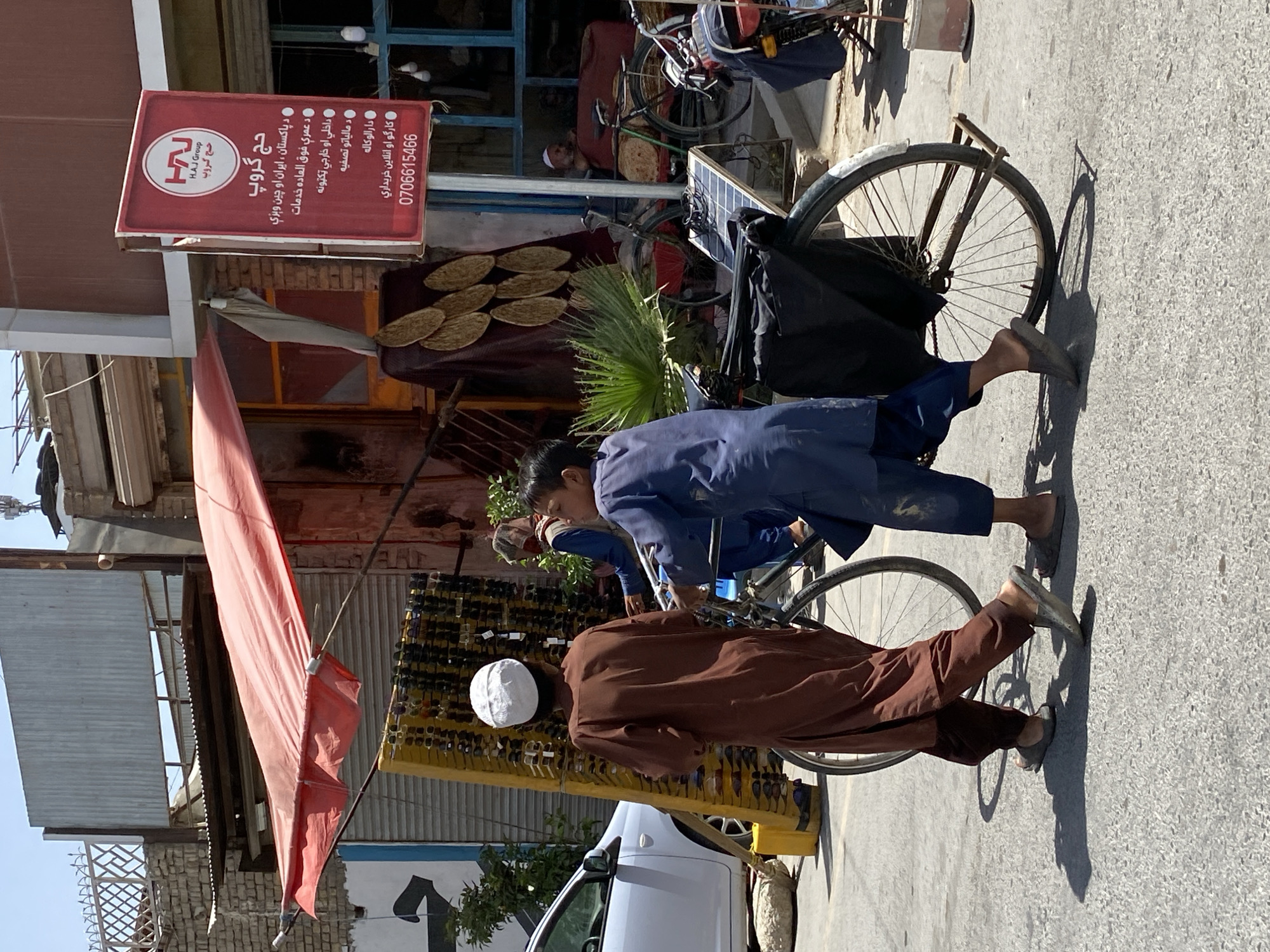 Everyday street life in Kandahar, vendors and pedestrians mid-morning