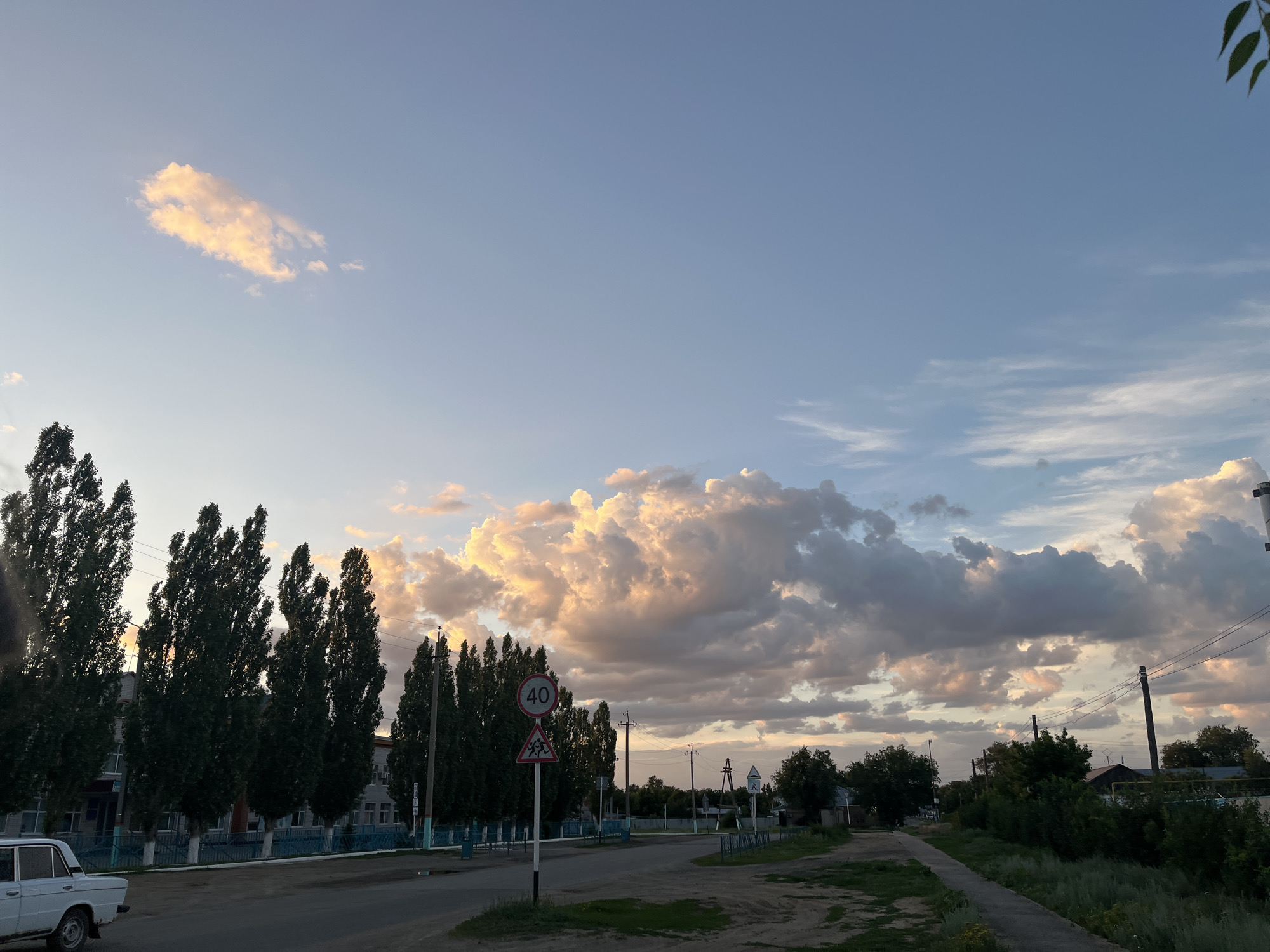 Golden hour light over Qobda streets and open sky