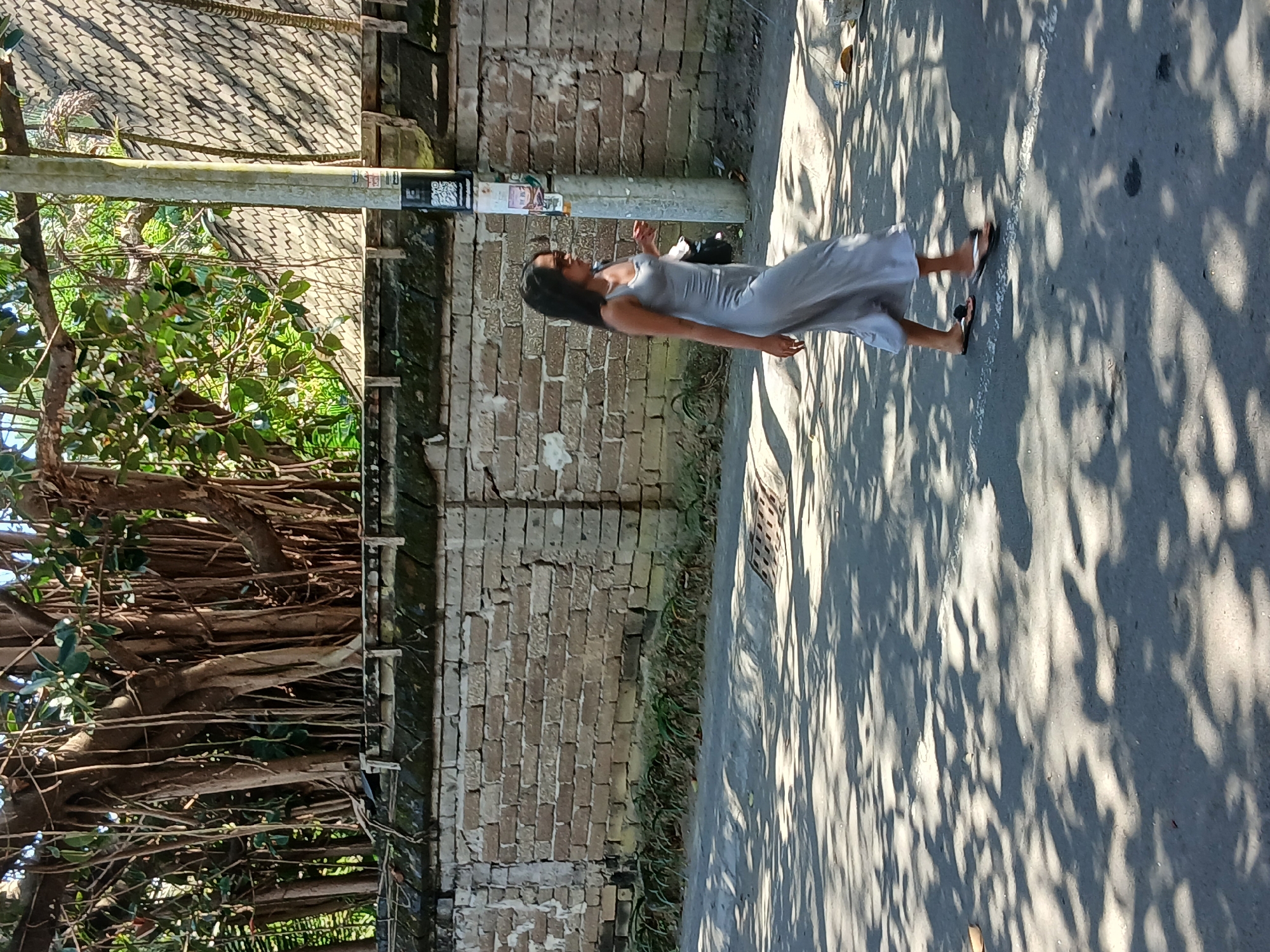 Foot traffic and scooters along Mengwi's temple-side streets