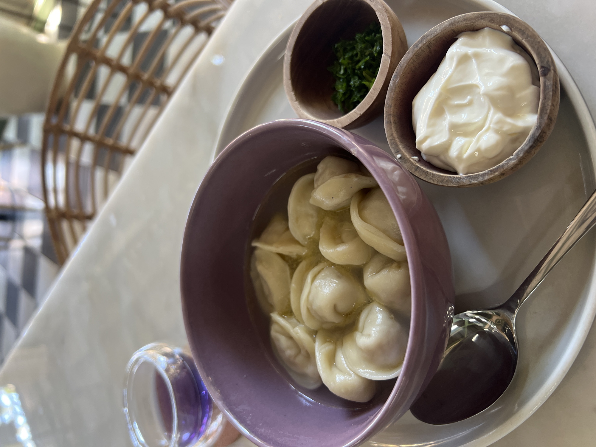 Diner enjoys dumpling meal with laptop in Sukawati