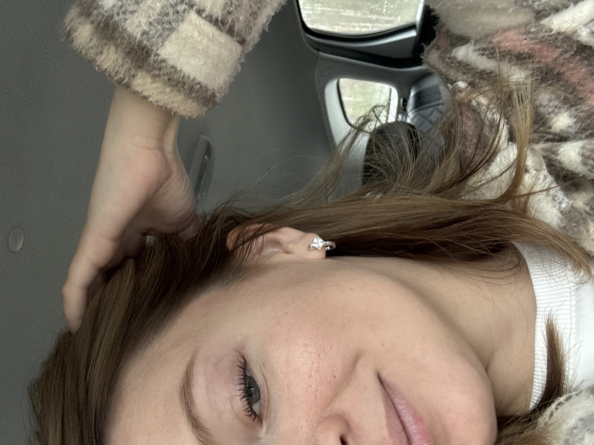 Woman takes selfie in car in Niva, Russia