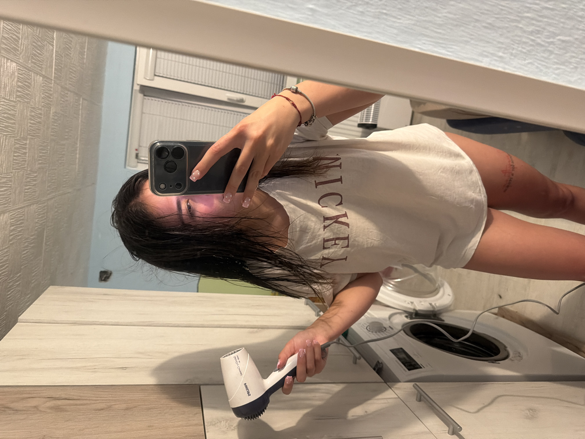 Woman documents hair-drying routine in Bulgarian bathroom selfies