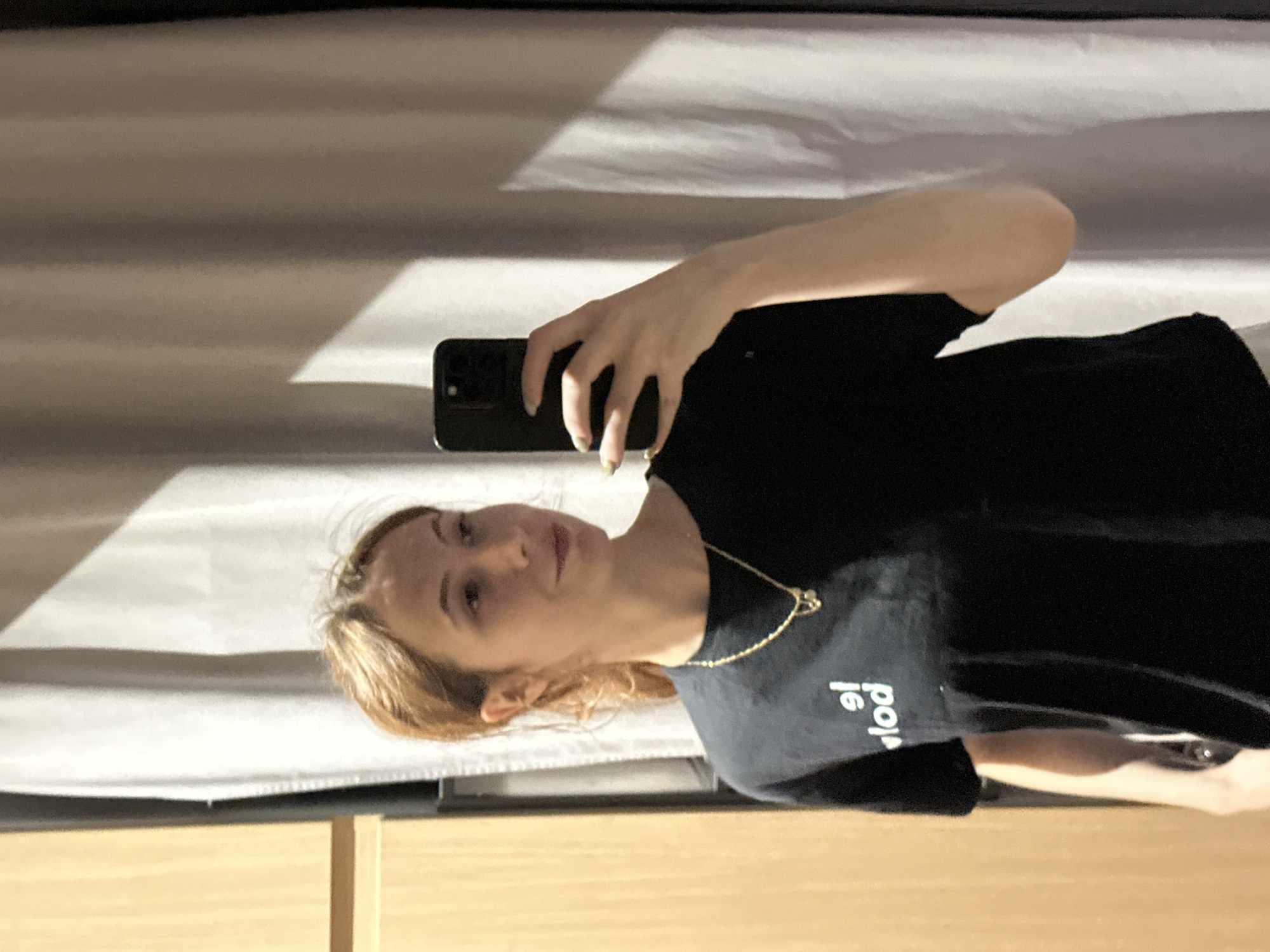 Woman takes selfies indoors in Novi Sad, Serbia