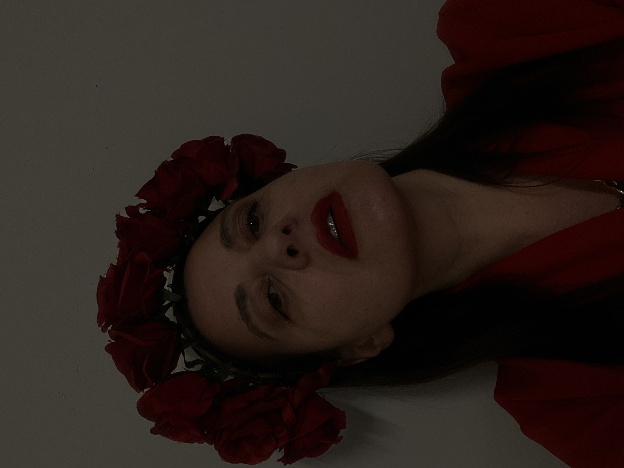 Woman in red rose crown photographed in Riga