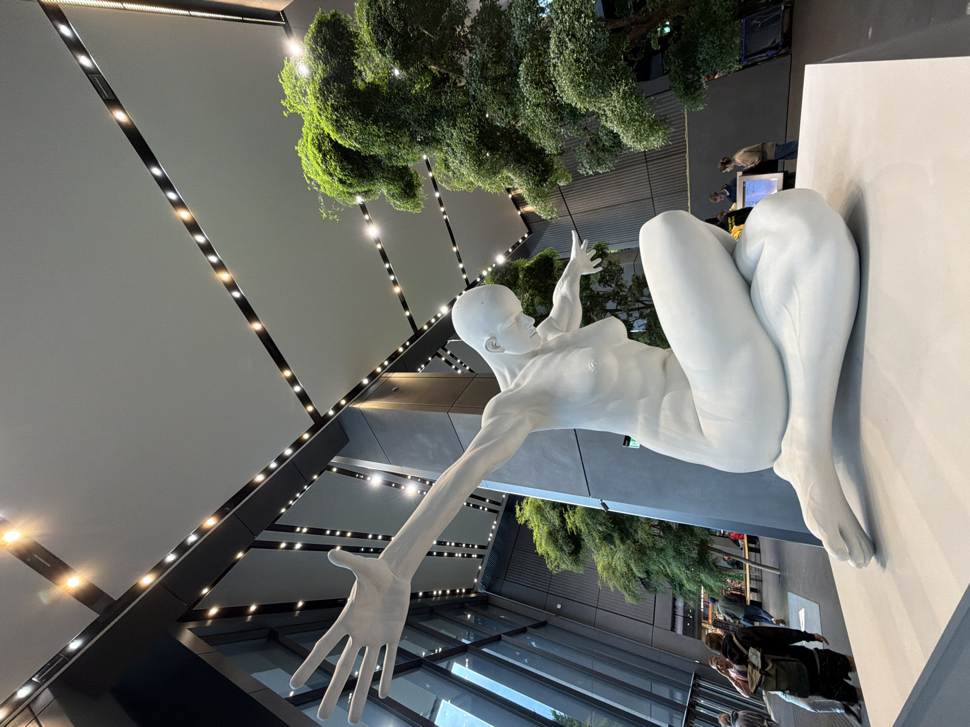 Abstract white sculpture anchors a Warsaw atrium lobby