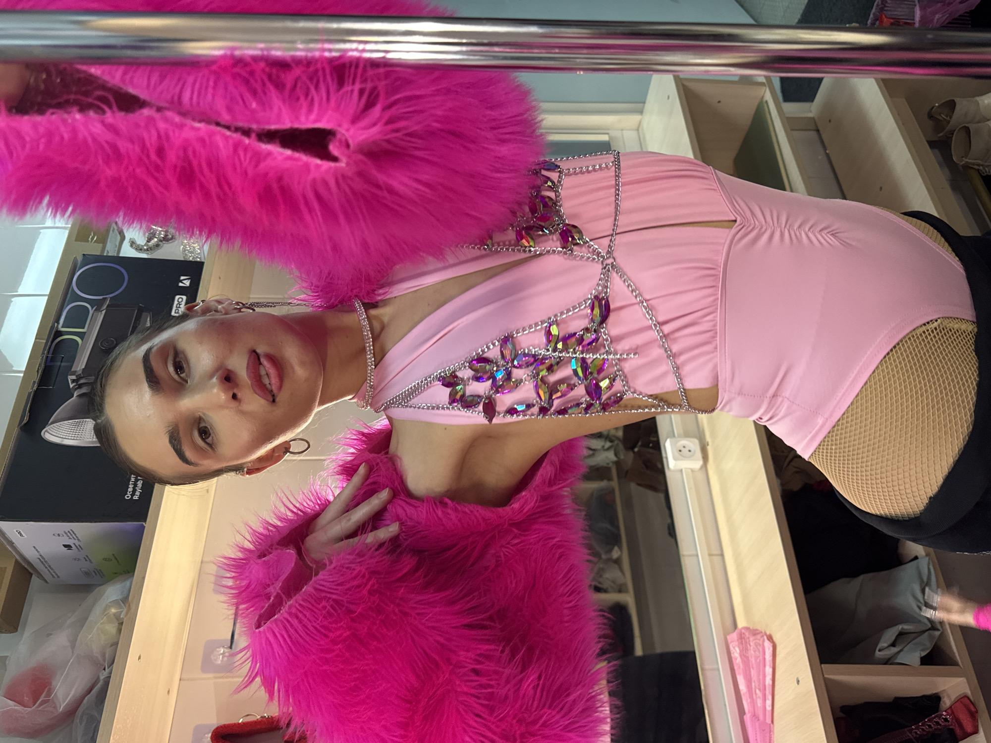 Women pose for photos in pink outfits in Kazan dressing room