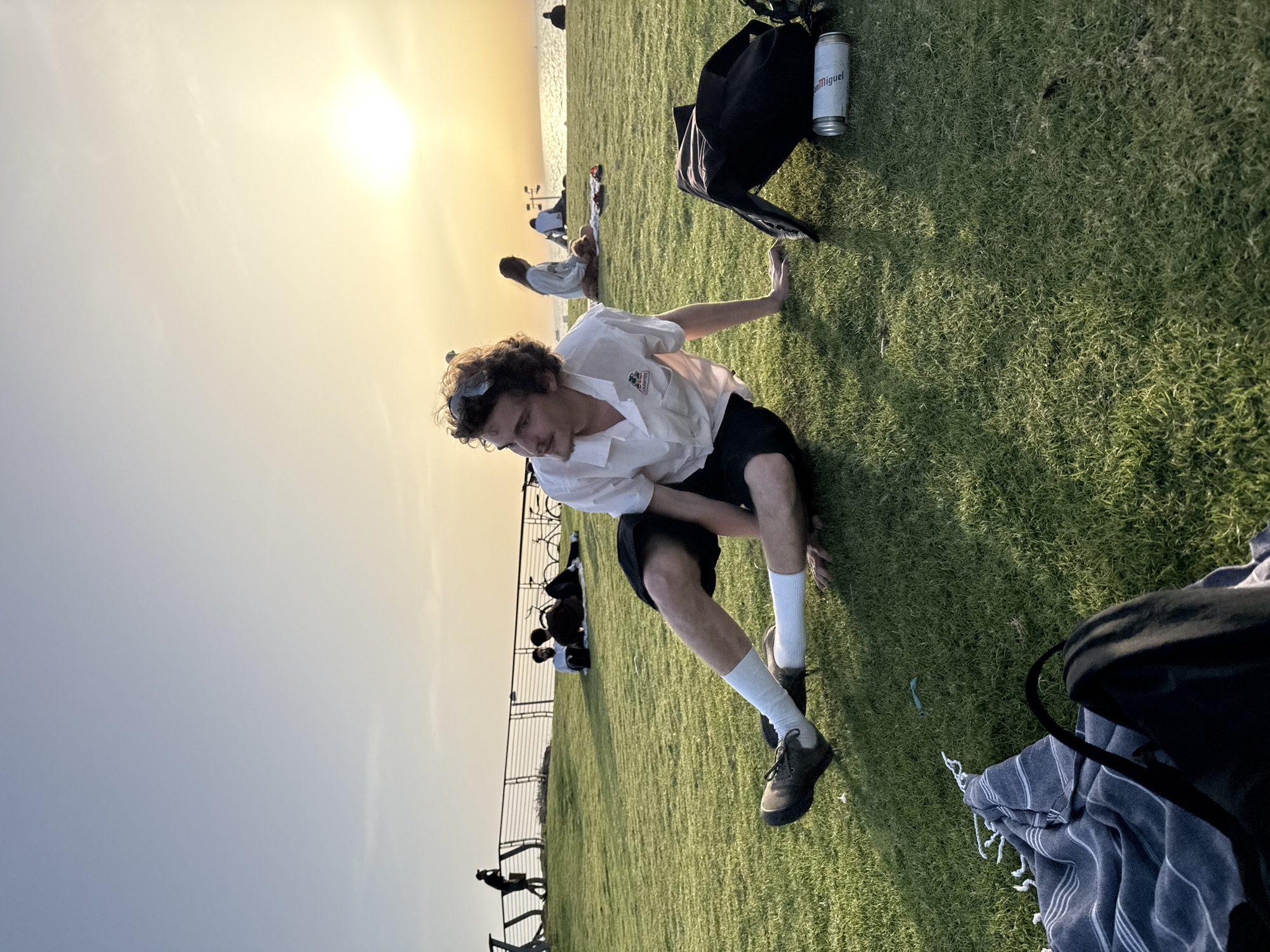 Young adults practice yoga in Tel Aviv seaside park