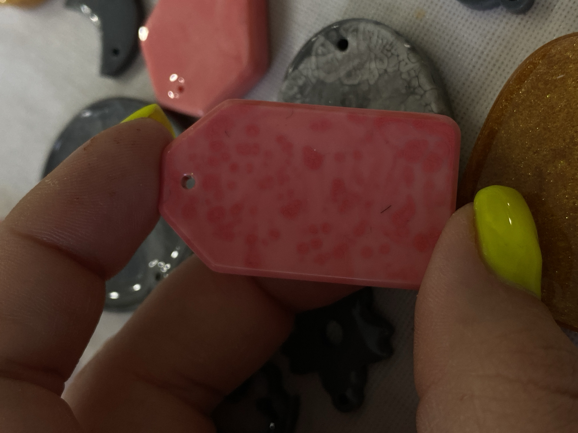 Handmade resin pendants and decorative clocks at a Balashikha craft session