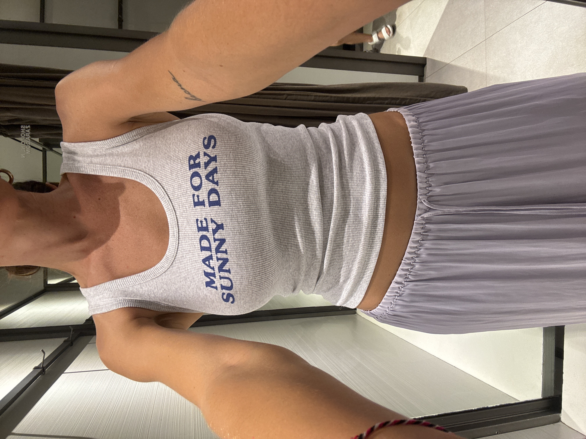 Shopper tries on summer clothes at Kuta retail store