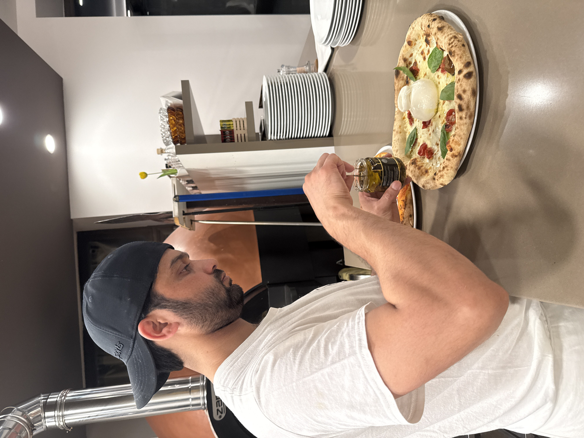 Behind the counter at a Trento pizzeria, craft pies take shape