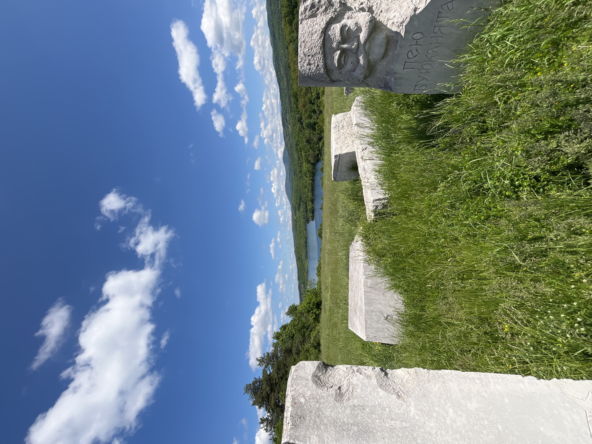 Three men tour historical stone sculptures in Bulgarian countryside