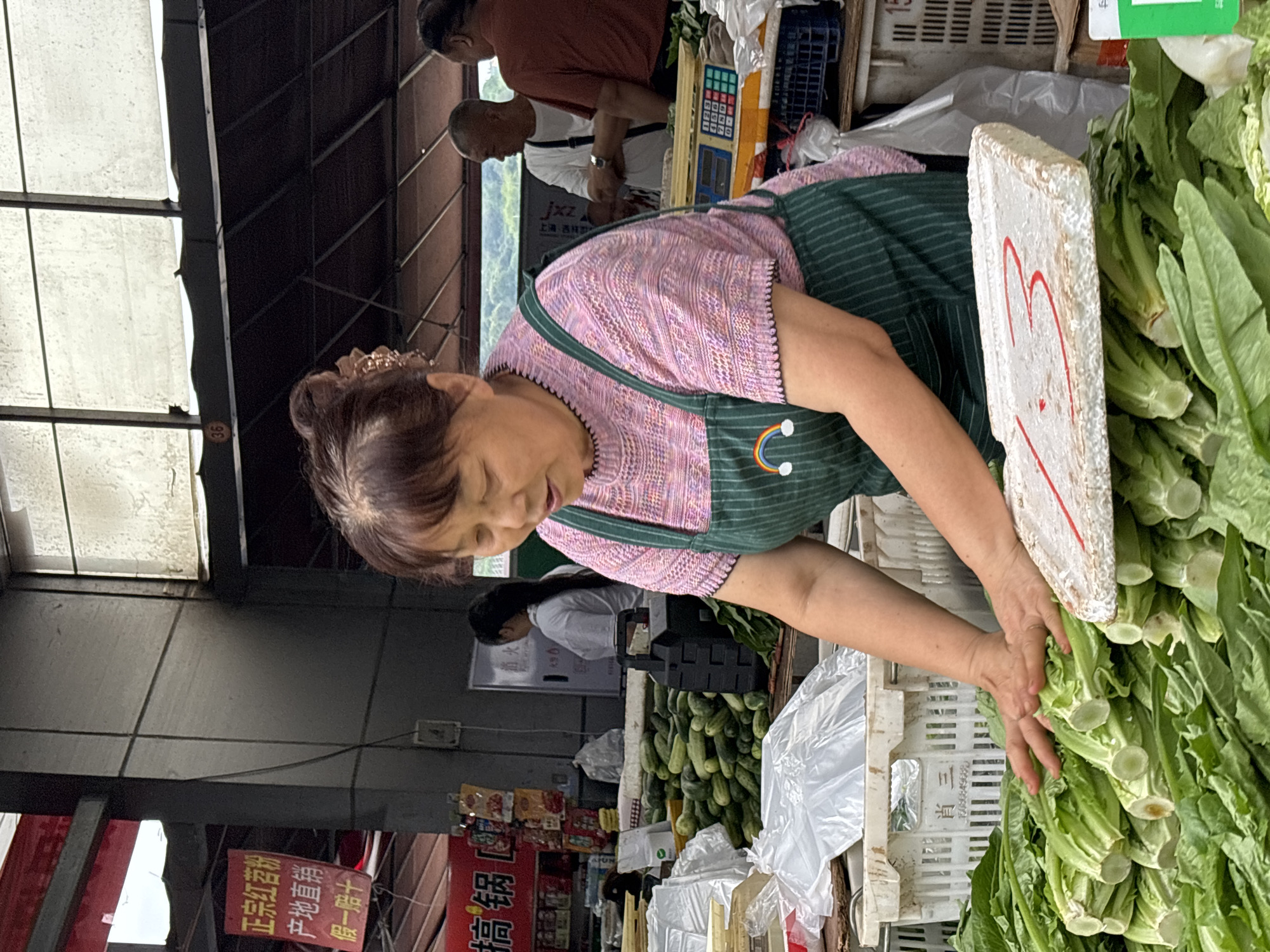 Morning market vendors serve customers in Jiangjin, China