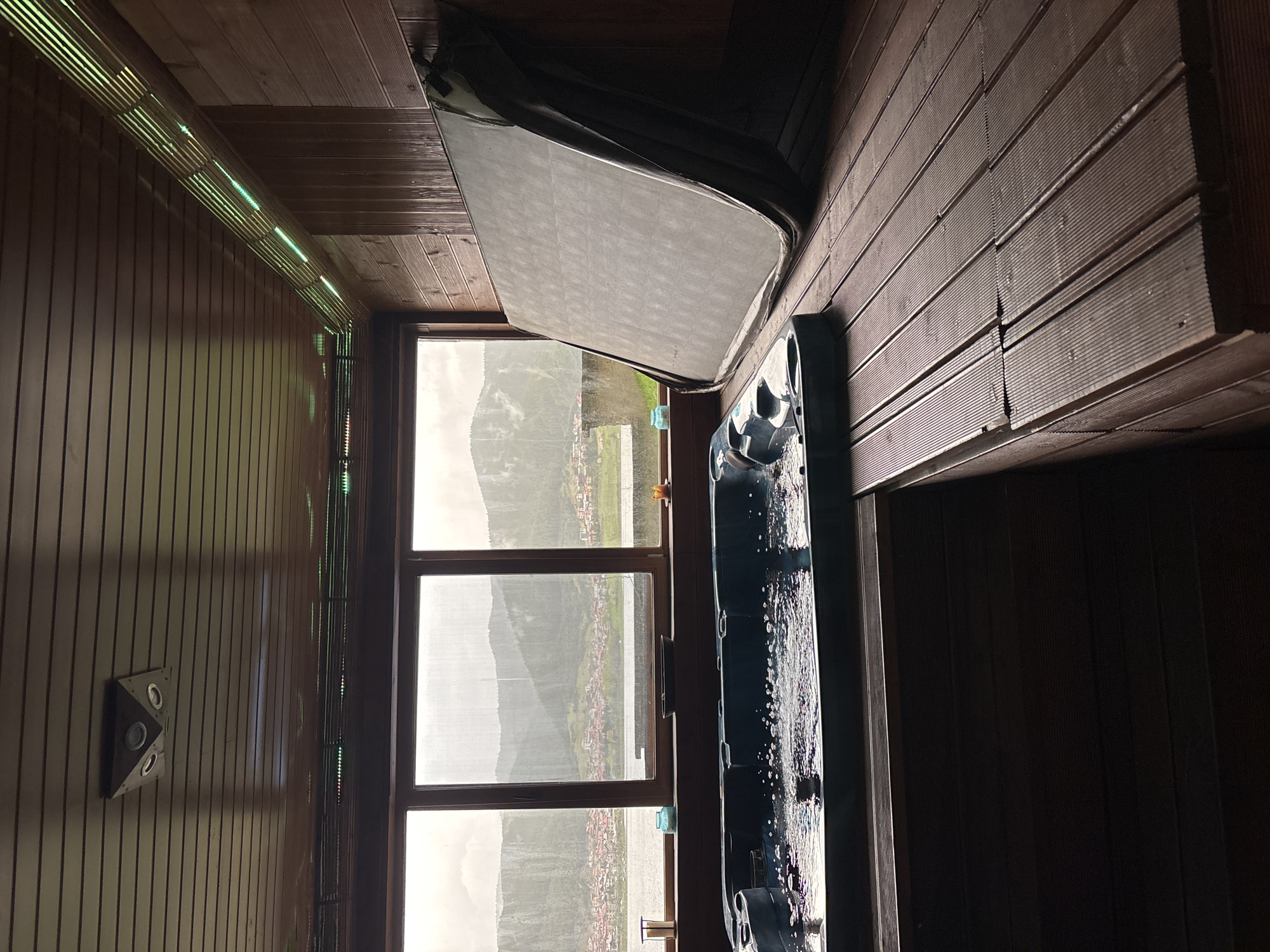Indoor wooden hot tub enclosure documented by witness