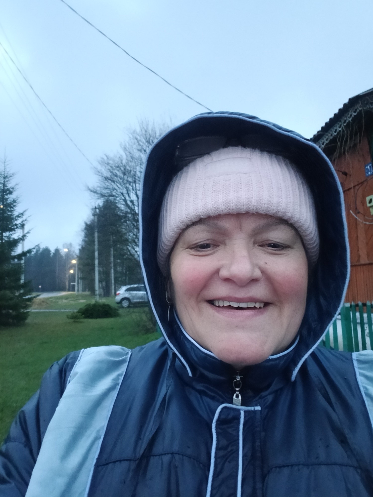 Woman documents rainy afternoon walk in Russian village