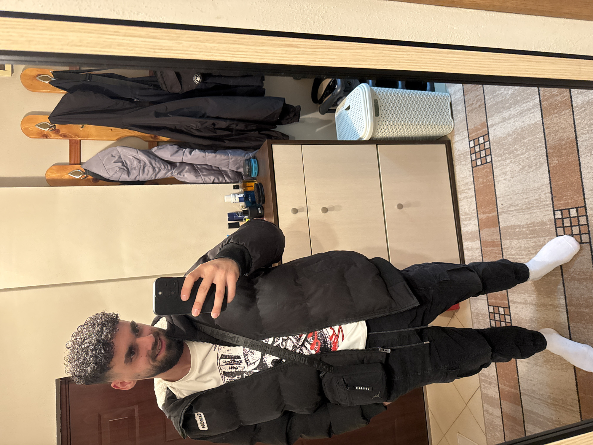 Man Takes Mirror Selfie in Interior Setting