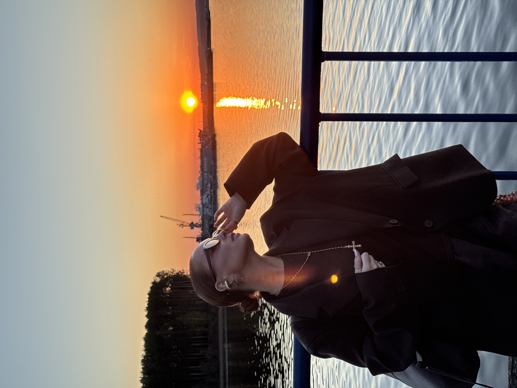 Woman captures sunset selfies along Kama River in Chaikovsky