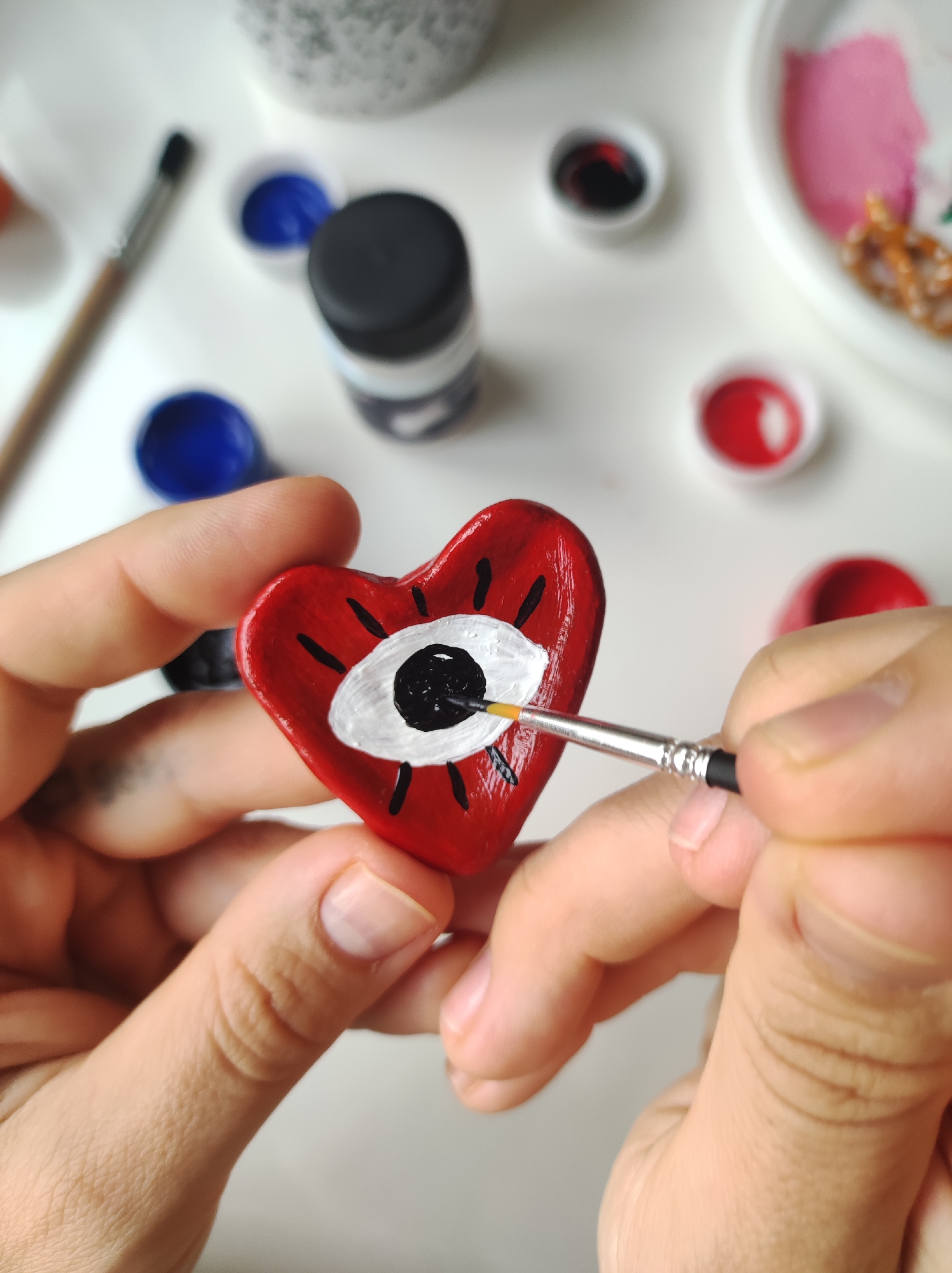 Artist creates eye-themed art while wearing eye patches