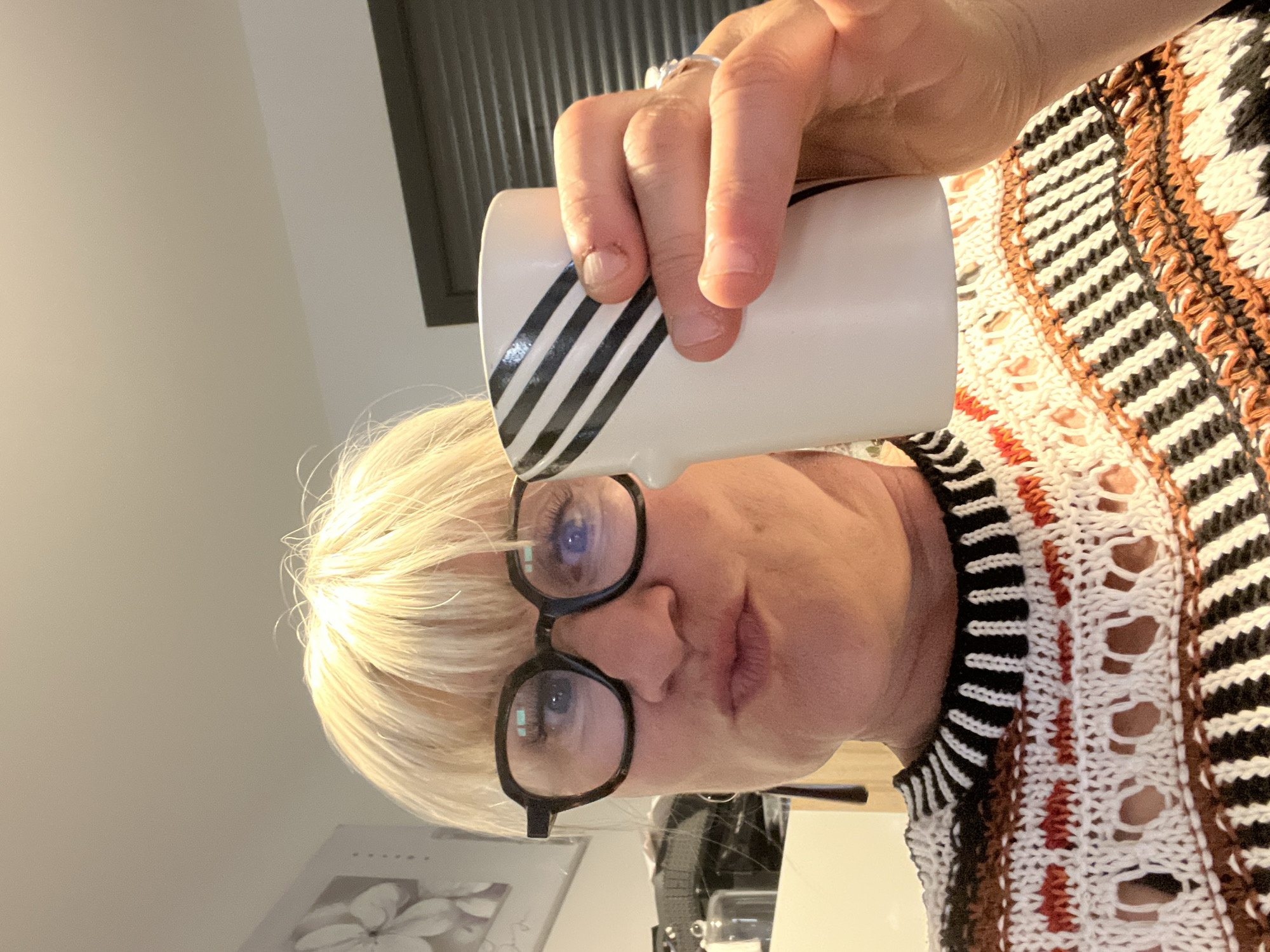 Woman with coffee mug observed indoors in Chambœuf