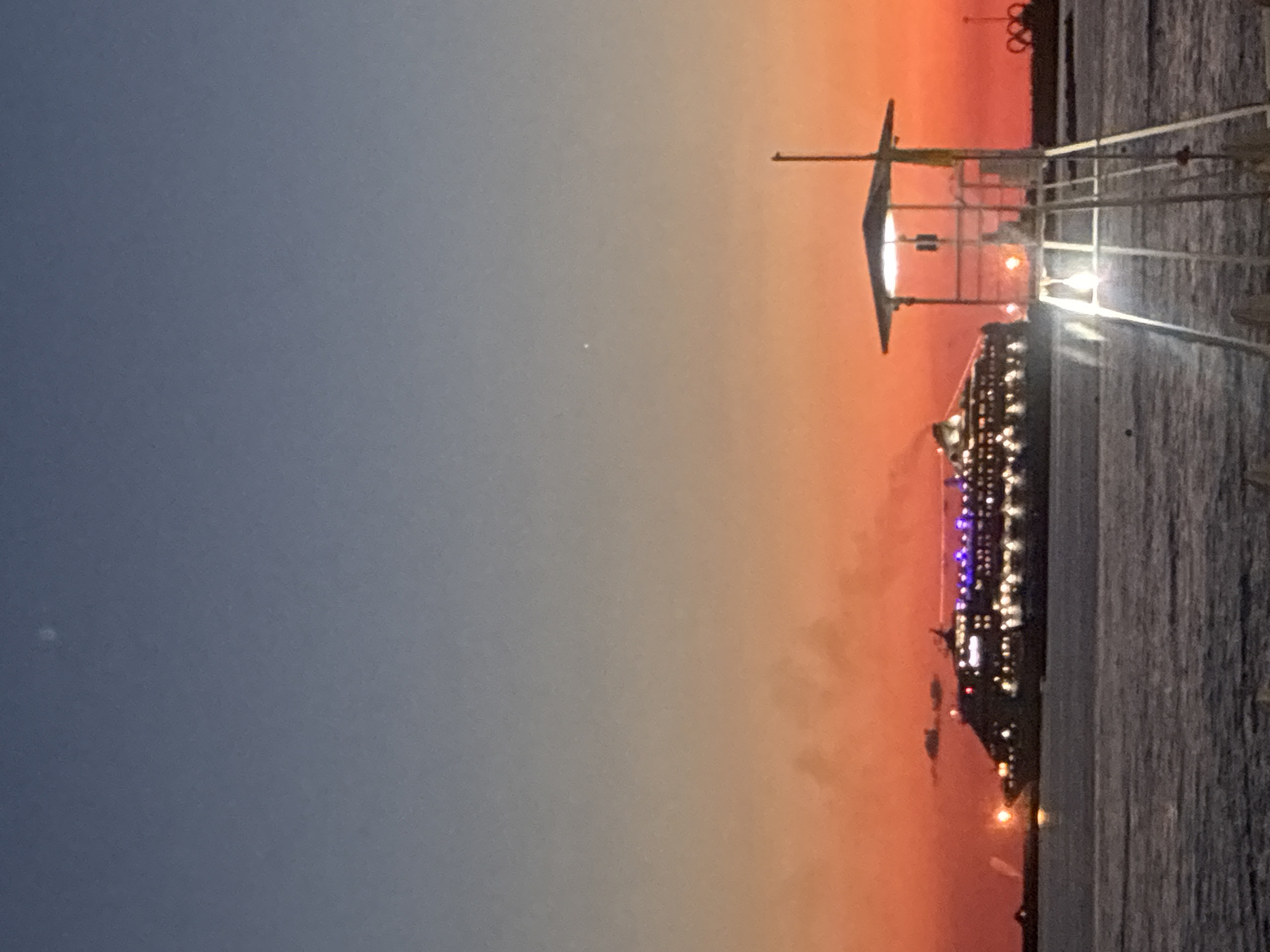 Cruise ship lights up Sochi harbor at twilight