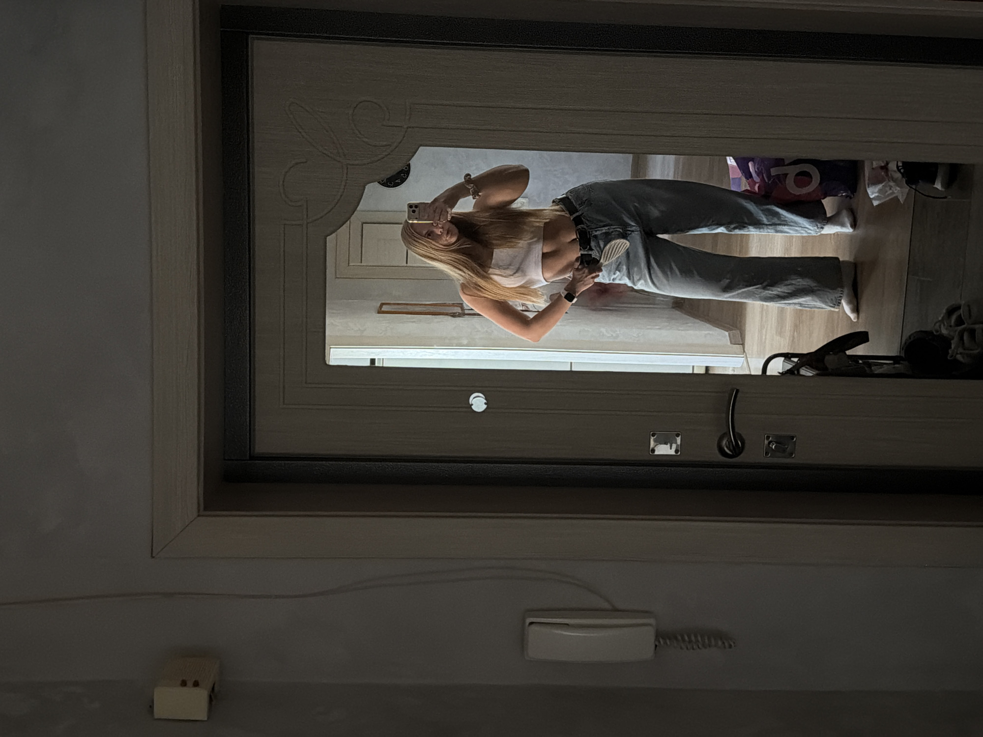 Woman takes mirror selfies during morning routine in Chaikovsky
