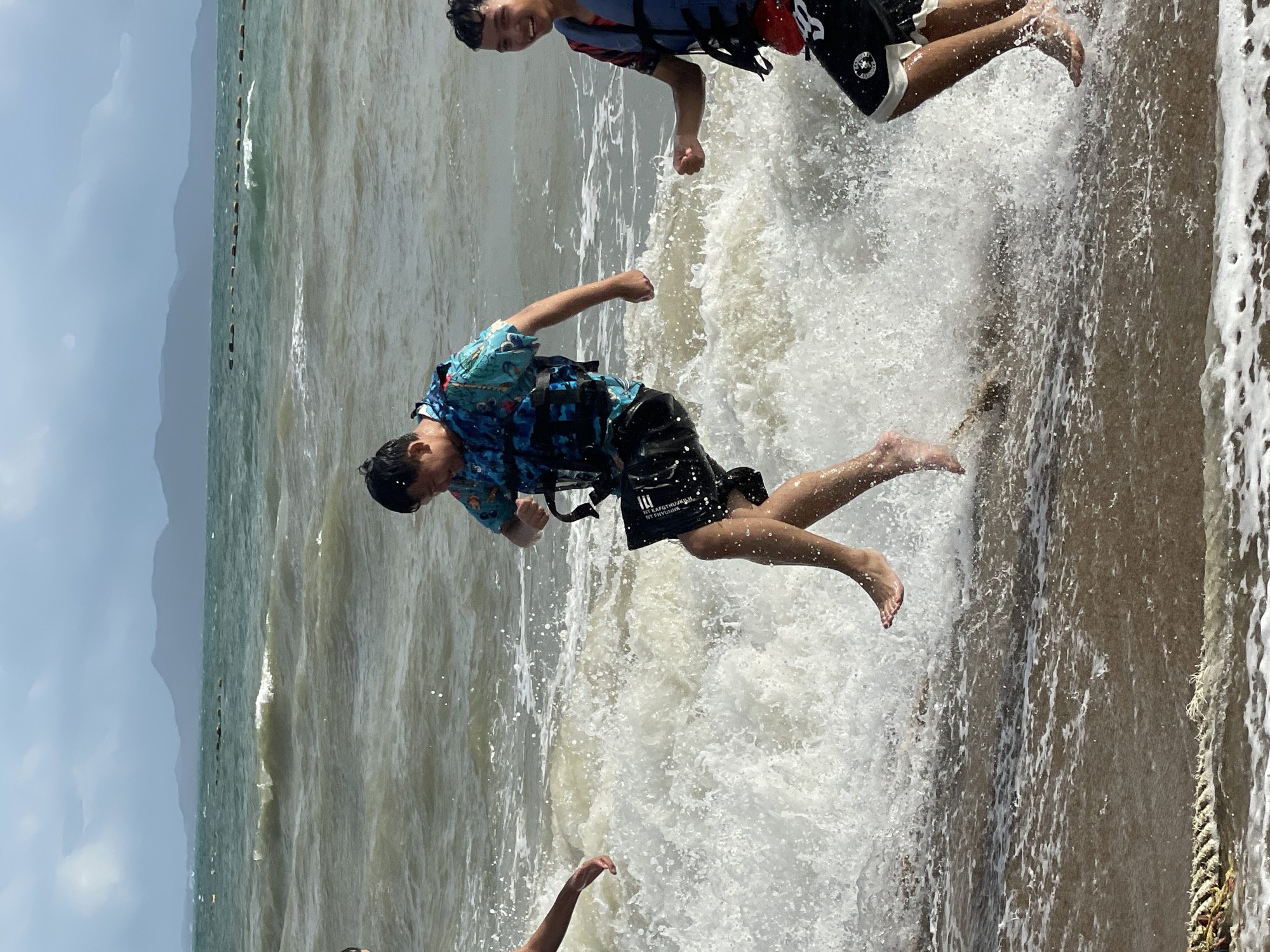 Rough surf and beach activity on a cloudy Pattaya morning