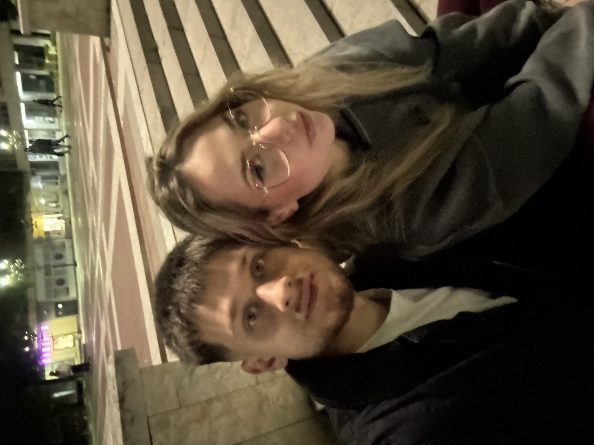 Couple takes evening selfies at illuminated Blagoevgrad fountain