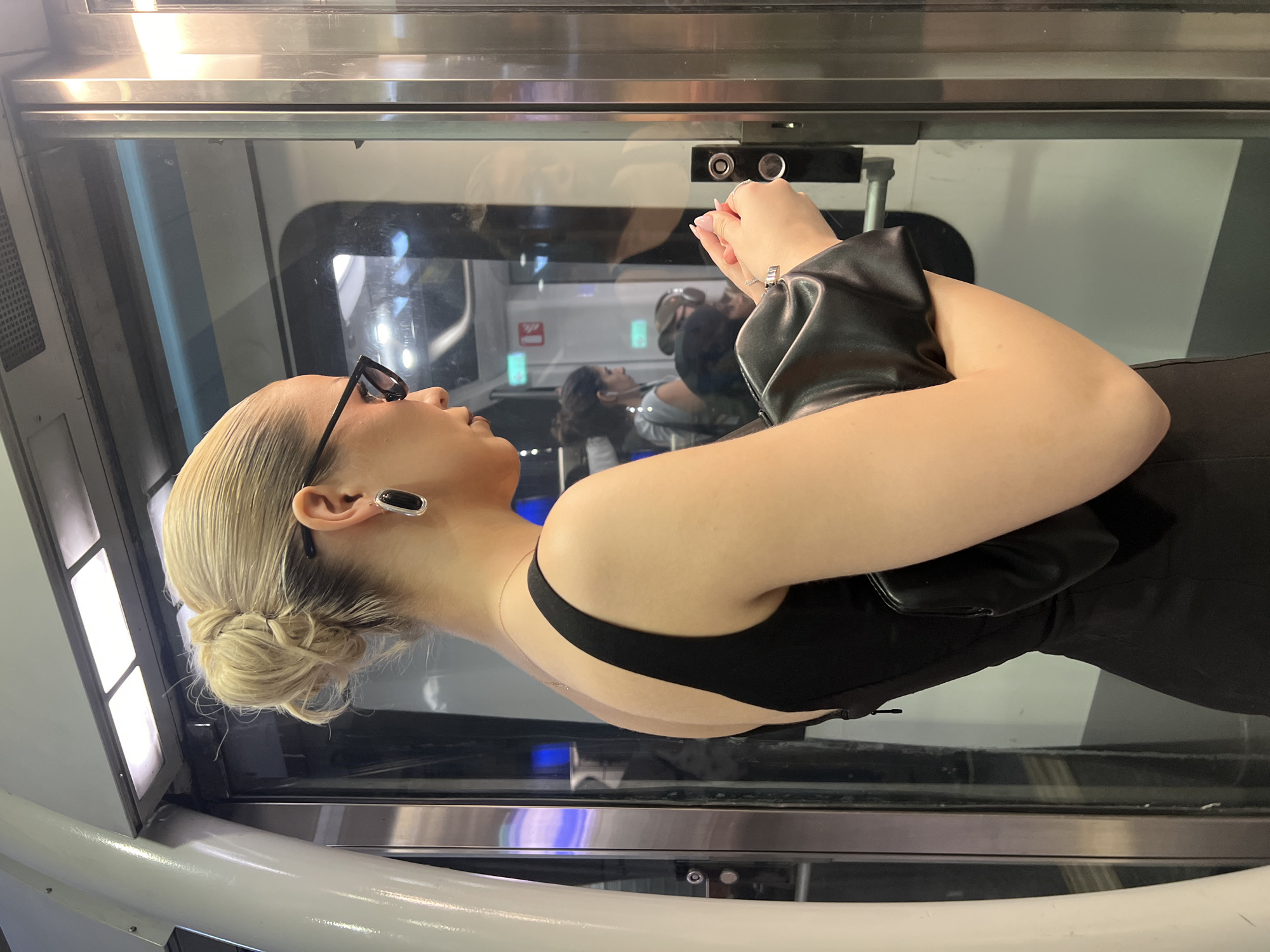 Woman in black dress observed in Paris elevator