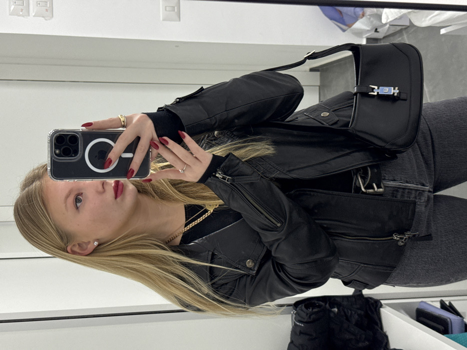 Woman Takes Selfie in Black Leather Jacket in Ariel