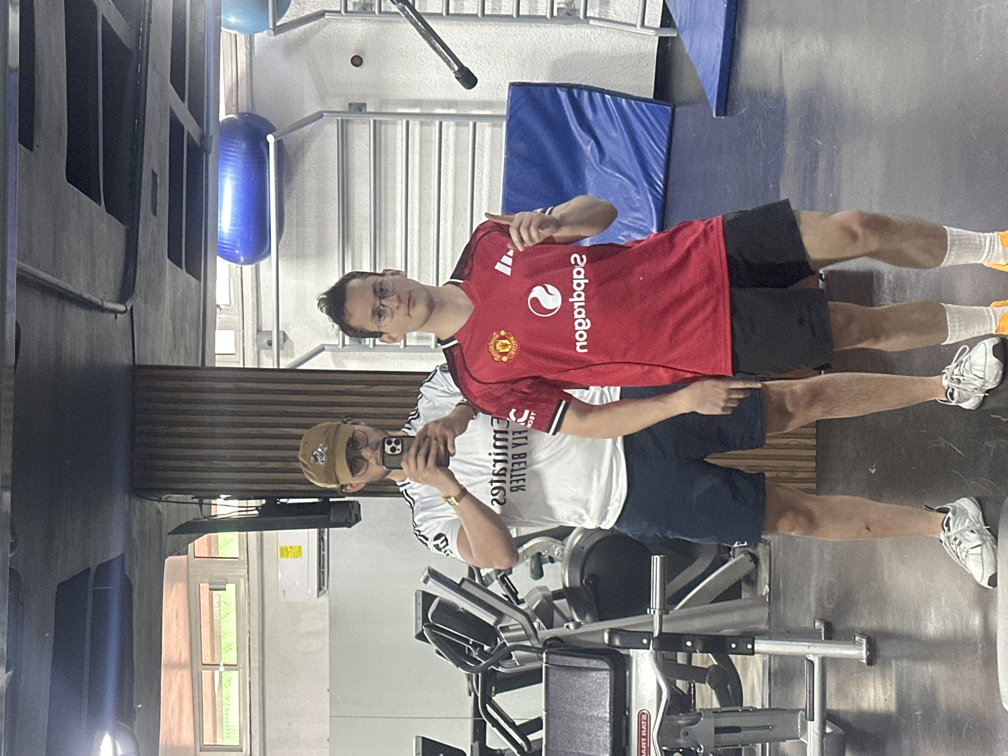 Two men take gym selfie in soccer jerseys