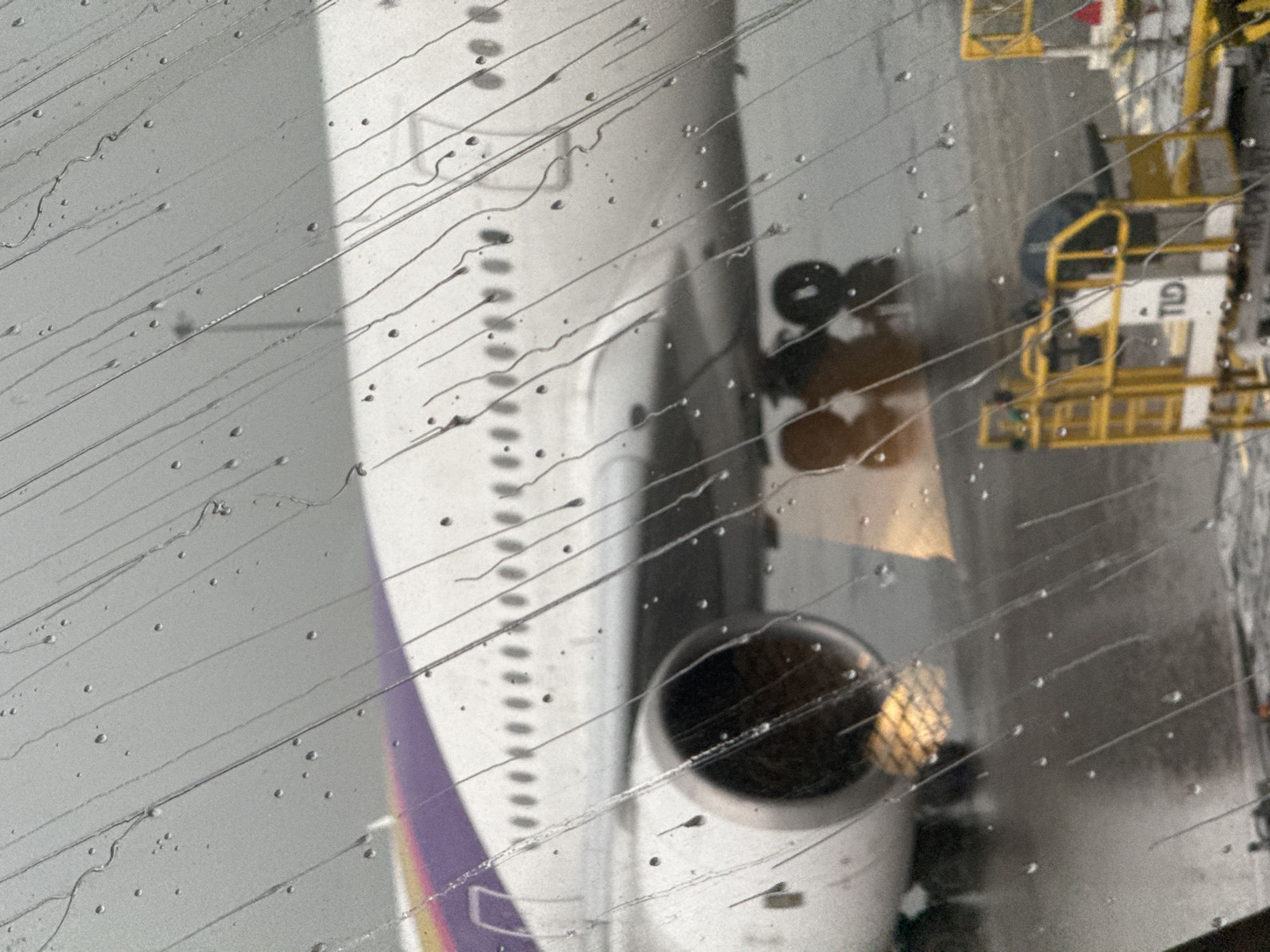 Rainy layover at Suvarnabhumi, planes on the tarmac