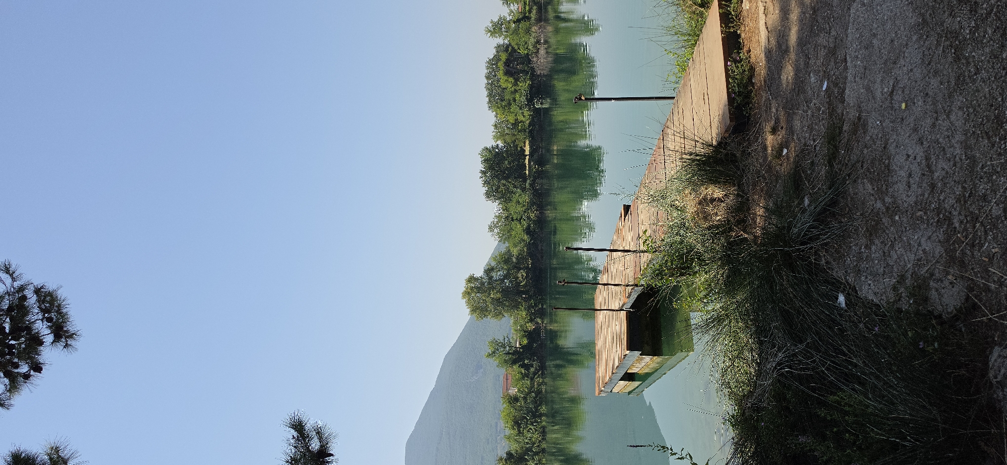 Peaceful lakeside scene in Solopaca: dock, duck, and fish