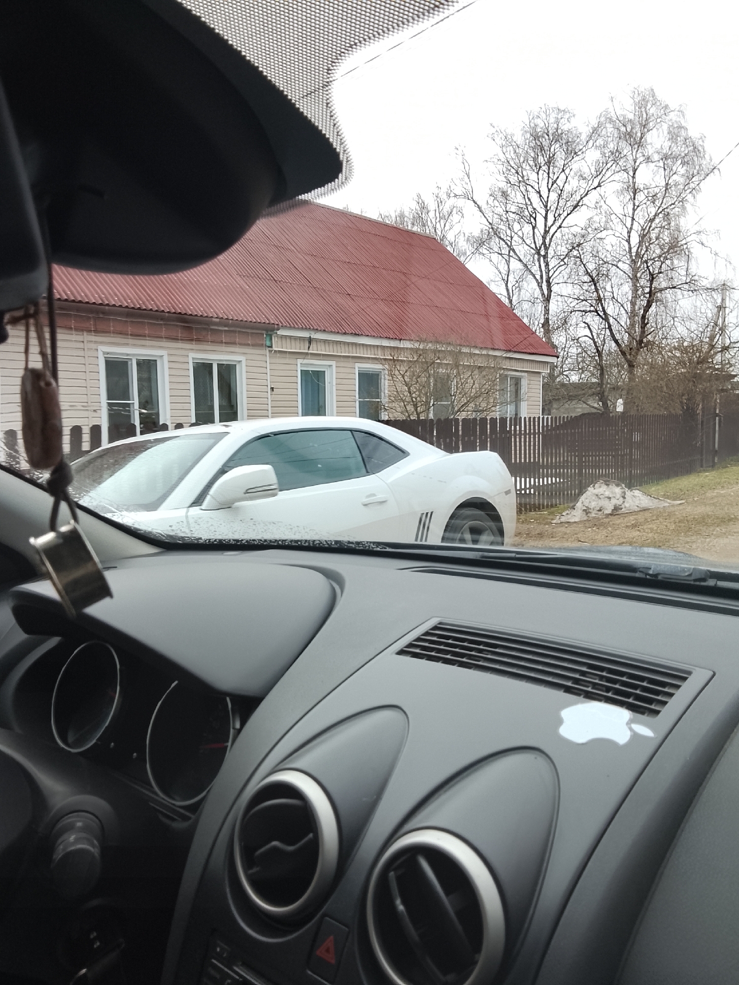Morning traffic observed in Vysokinichi, Russia includes parked Camaro