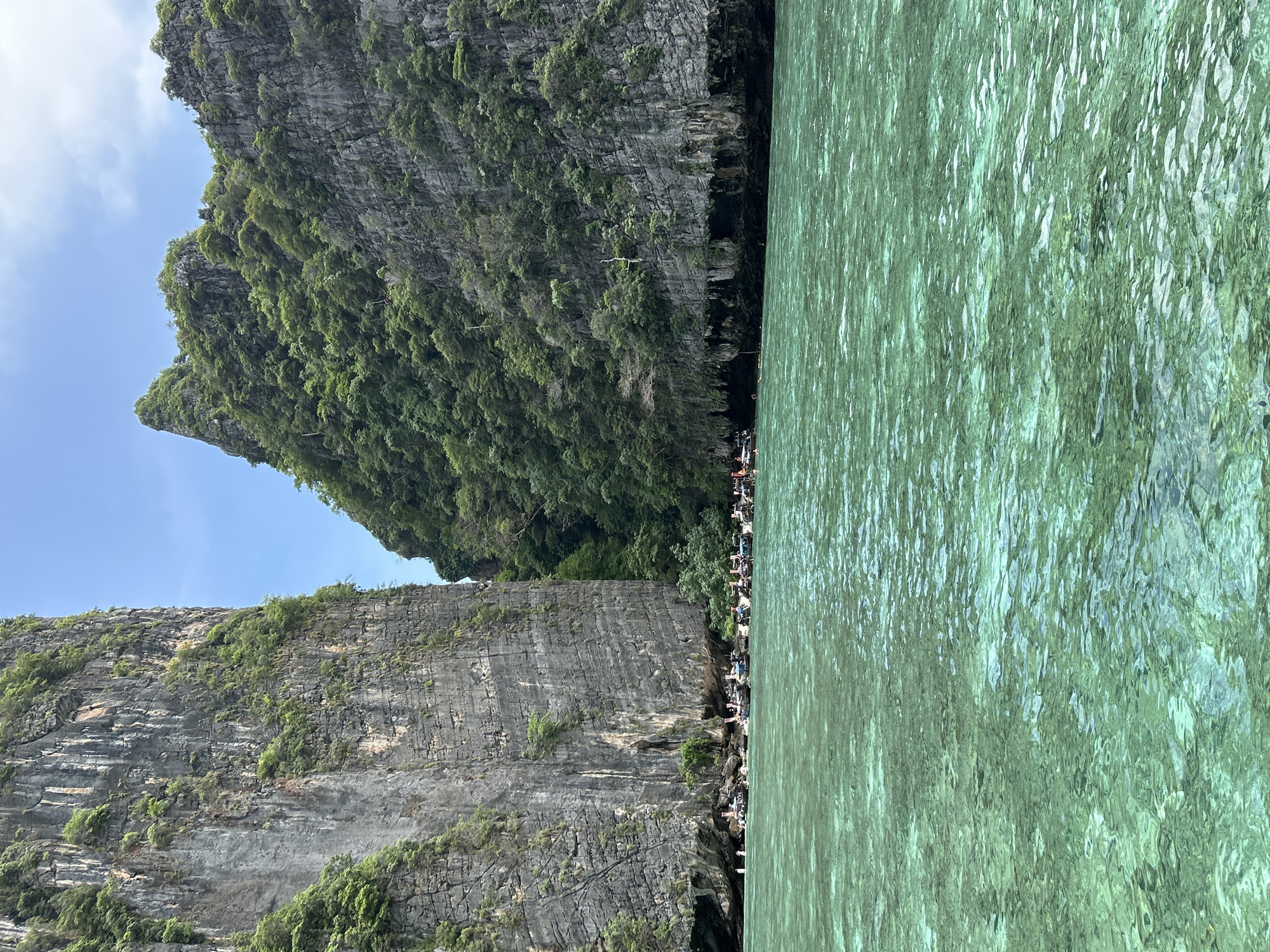 Limestone cliffs and clear water at a Haad Yao cove