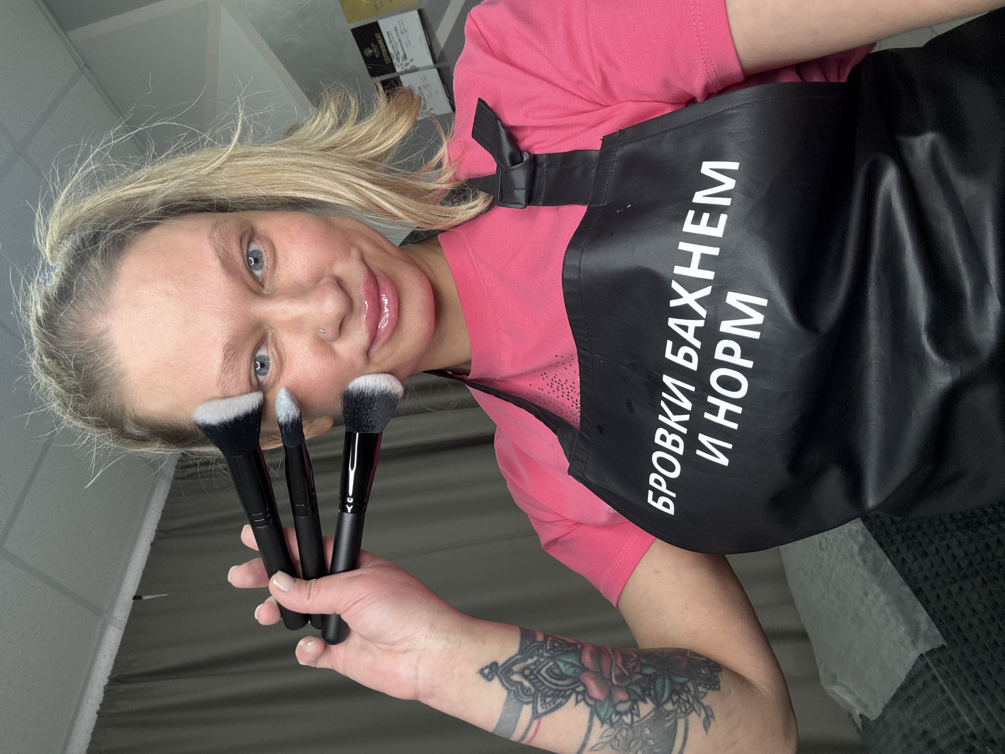 Woman photographs herself with makeup brushes in Perm